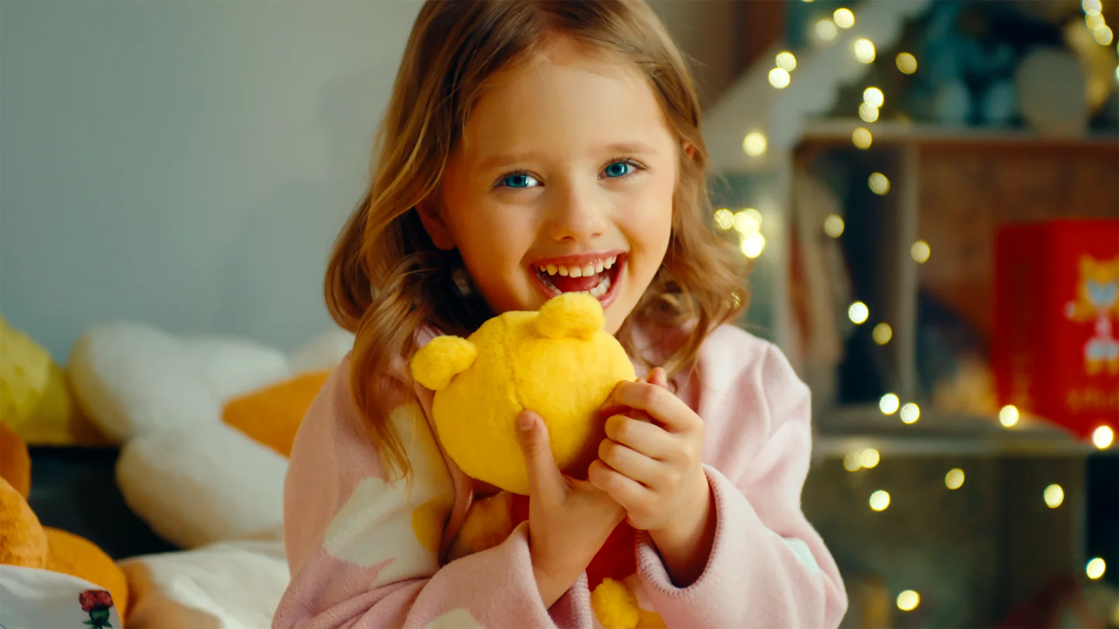 A girl hugging her Smish plush toy
